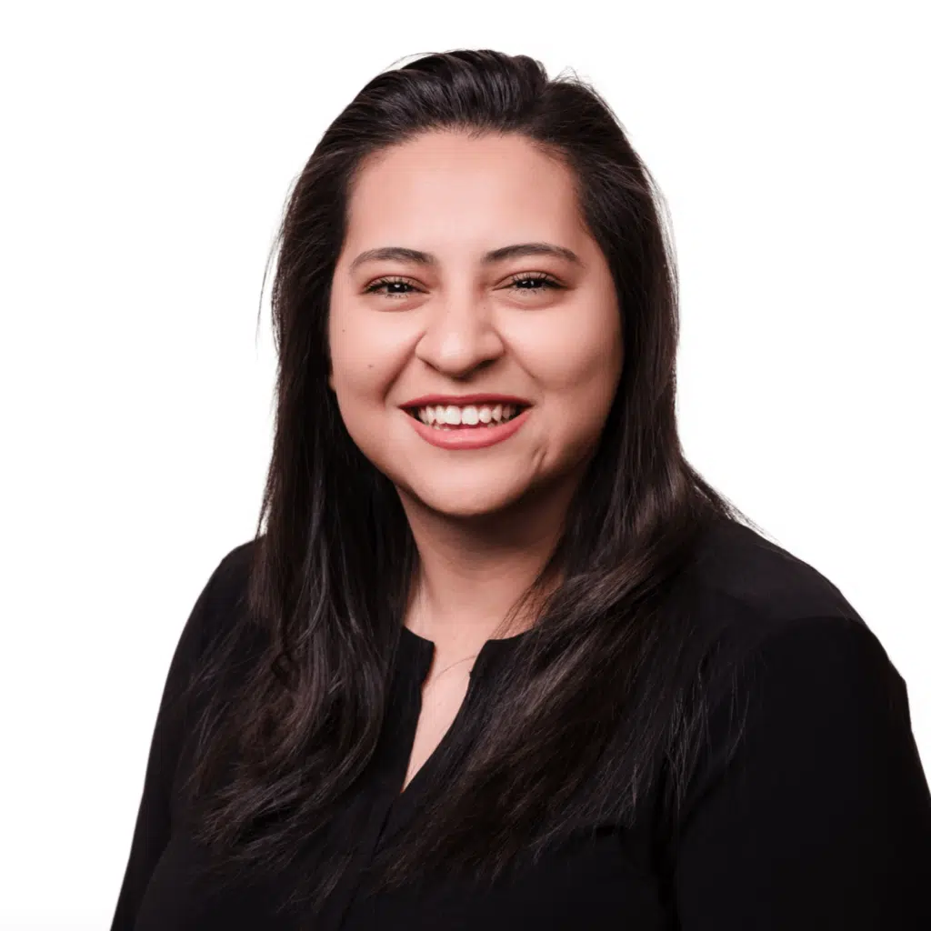 Professional headshot of Viridiana 'Vee' Rodriguez, a bookkeeping and payroll specialist at Jones, Covey, and Company in Washington, NC. Vee provides dedicated support to local businesses, ensuring precise payroll and bookkeeping services. She is smiling in a black top against a white background.